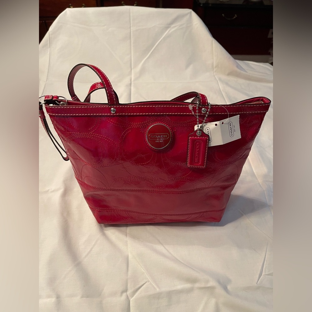 Red patent leather Coach double hand shoulder bag.